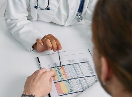 A Medical Practitioner Showing a Patient Paper