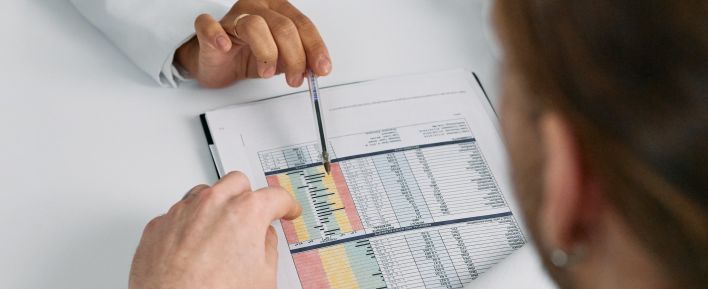 A Medical Practitioner Showing a Patient Paper